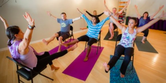 adults practising chair yoga