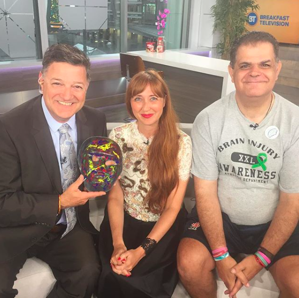 Kevin Frankish holds Frank's mask 'What's Wrong Look Inside' with Melissa Vigar and Frank Bruno